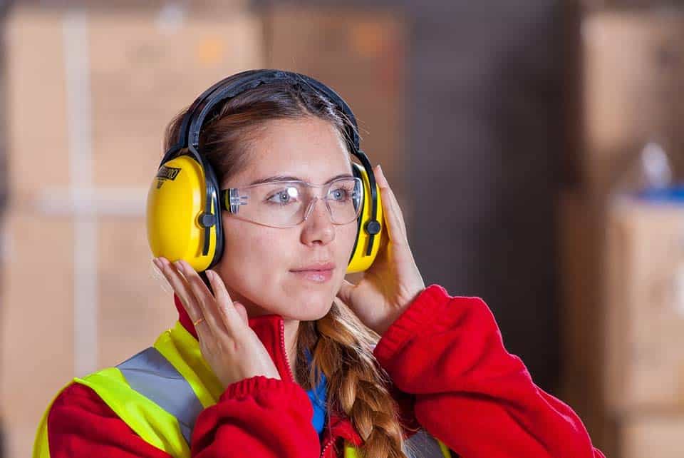 a construction worker wearing safety goggles and ear protectors