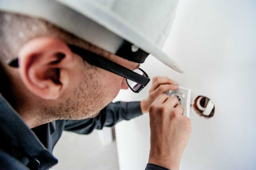 Electrician conducting building maintenance on commercial construction in Austin