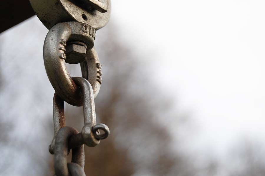 Close-up of swing chain, emphasizing the importance of playground maintenance in Austin Texas for safety and optimal performance.