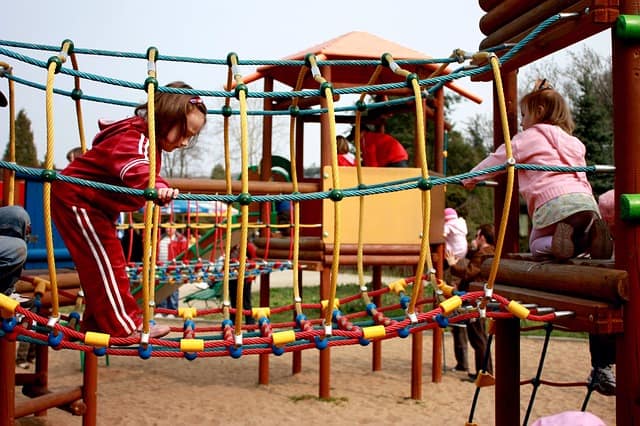 Children playing on new Austin playground equipment