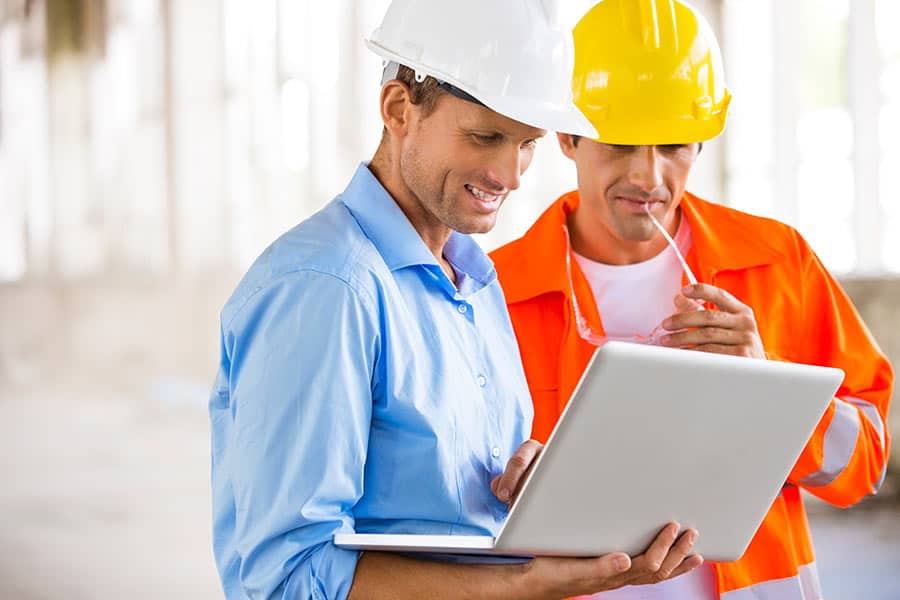 Construction men working on Laptop