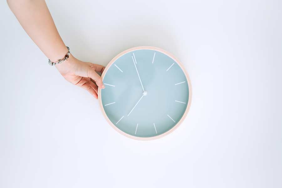 The Hand of a Contractor in Austin TX holding a clock