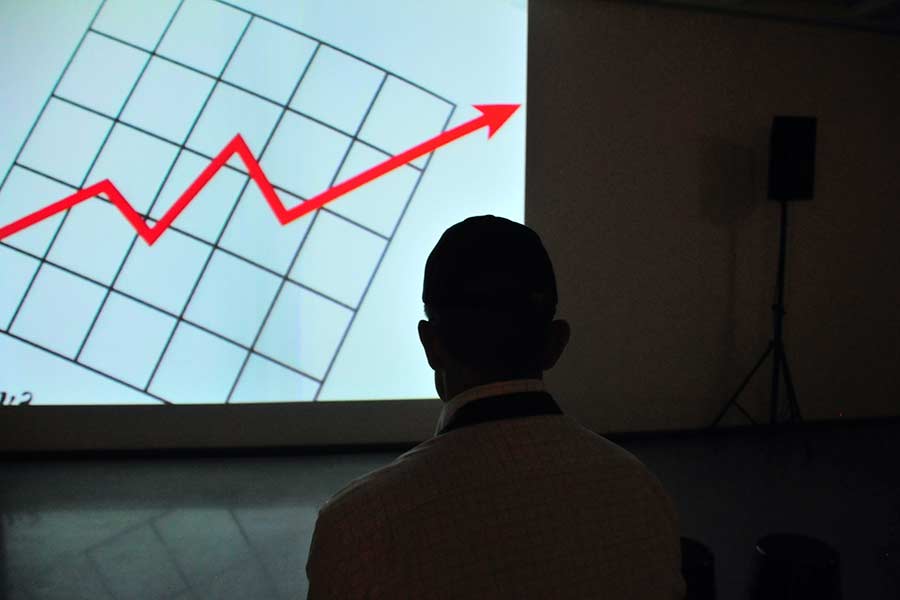 Man examining a chart on a projector