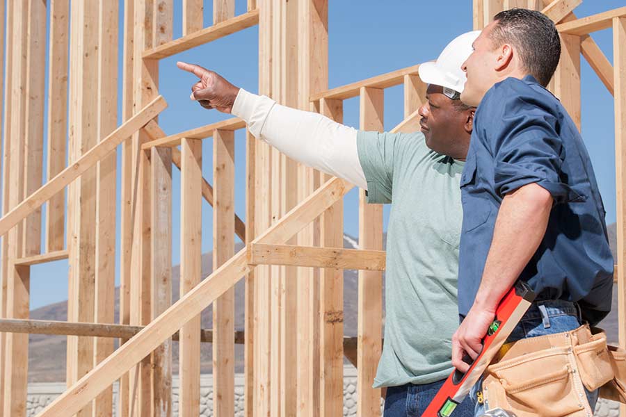 Contractor giving instructions to a builder on a job site