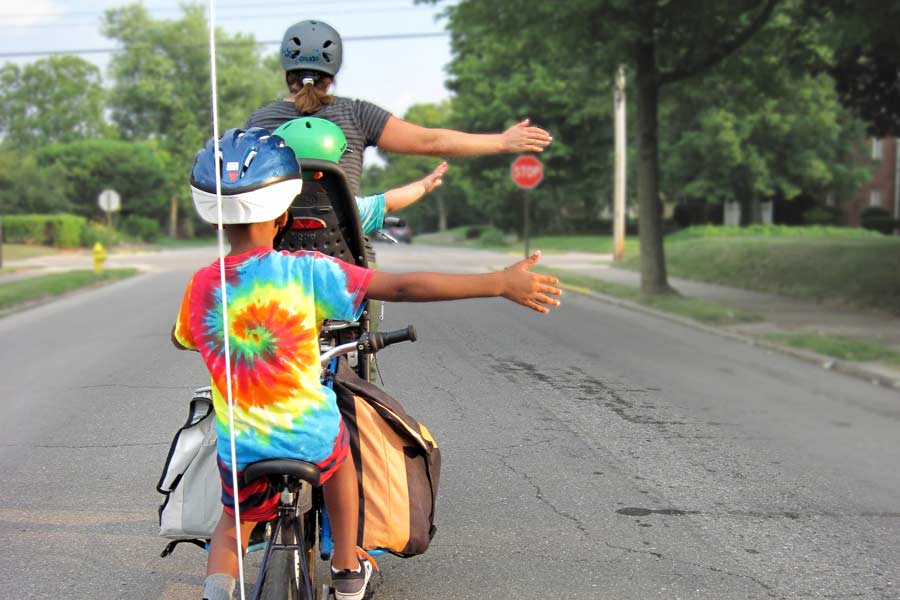 A family on bicycles riding to a playground installation in Austin