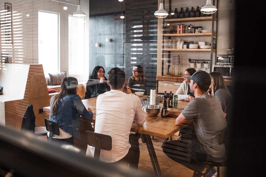 Office workers around a table at a lunch meeting