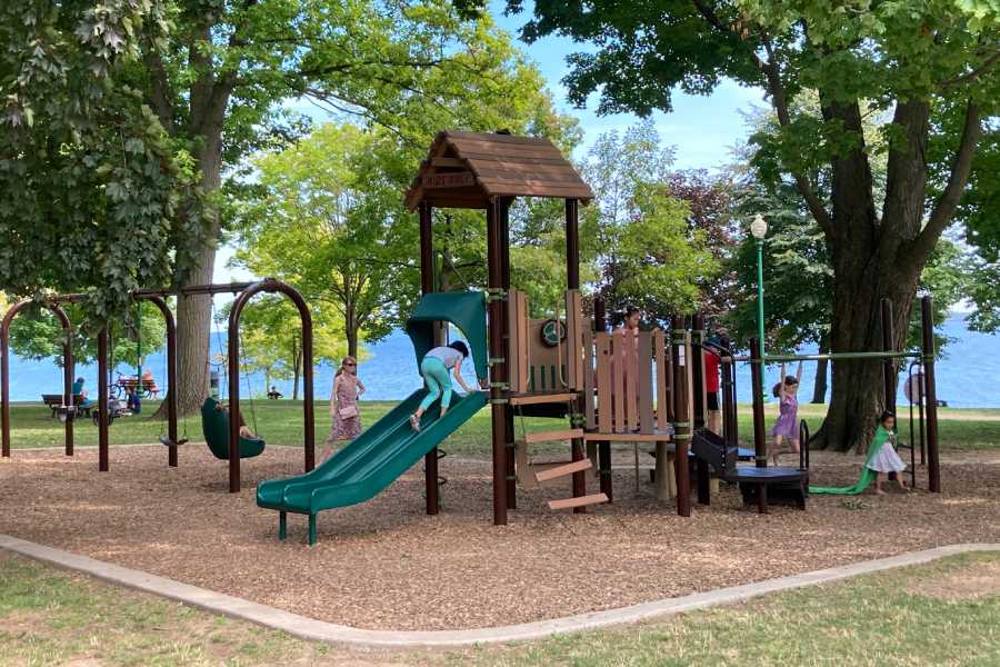 Kids playing in a new wooden Austin playground installation