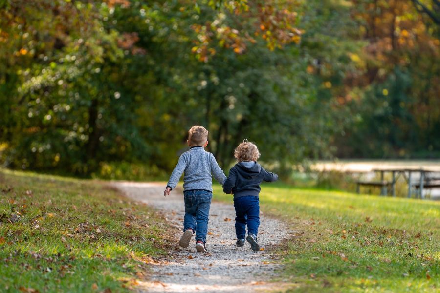 two young boys heading to the park to play together