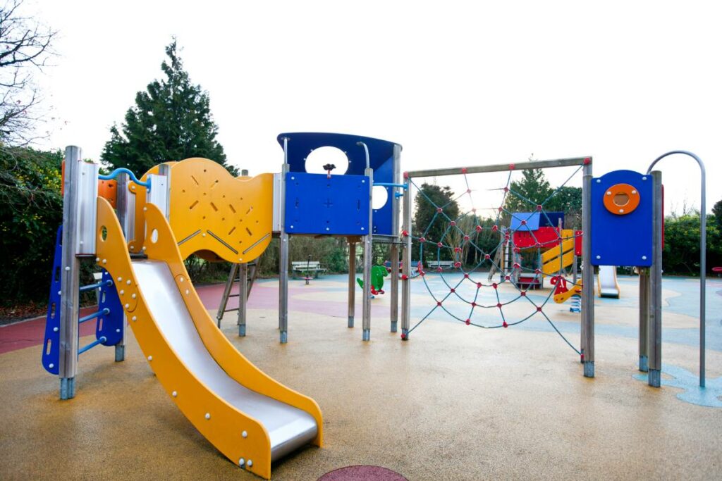 Vibrant Austin playground equipment featuring a slide, climbing ropes, and playscape for children to enjoy