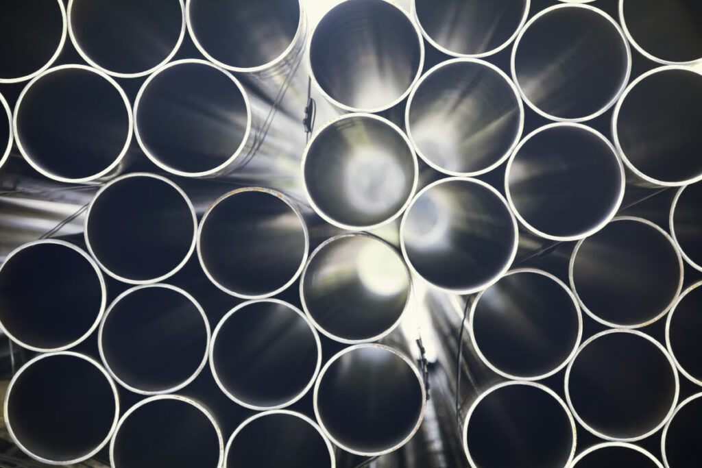 stack of steel pipes with light shining through