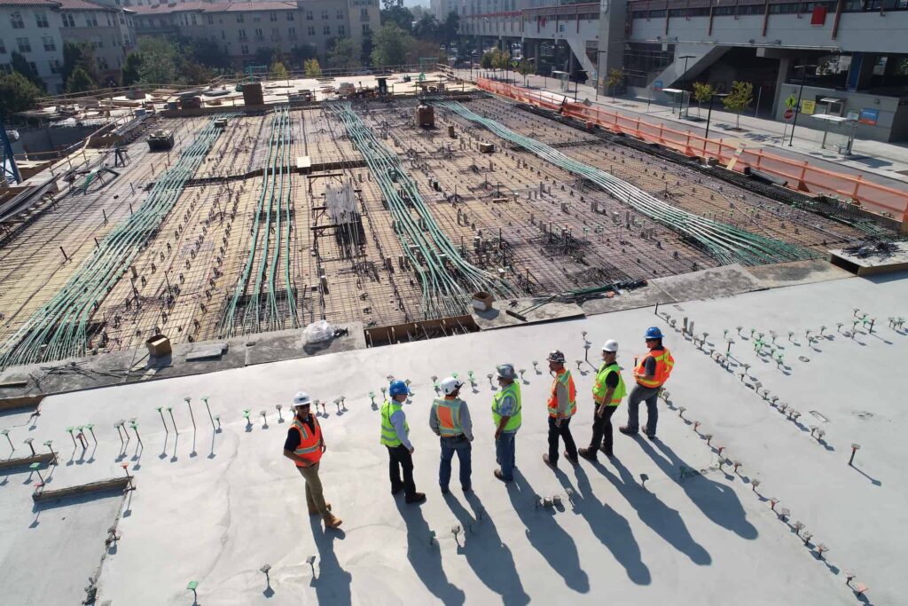 Group of construction workers standing in front of a building construction