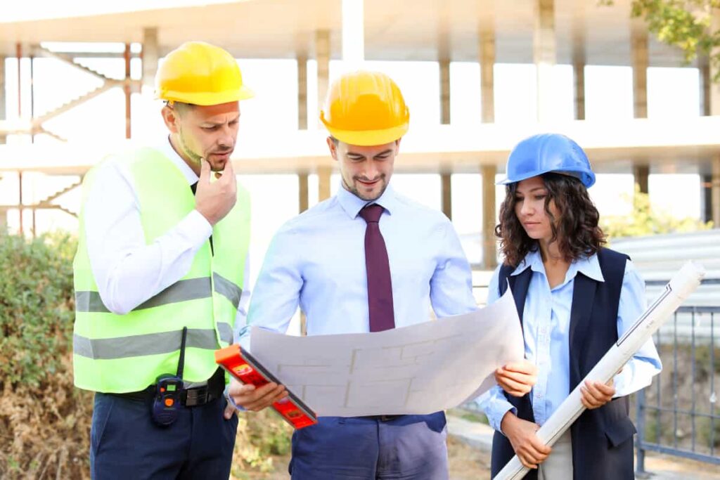 Workers discussing the building design applying JOC