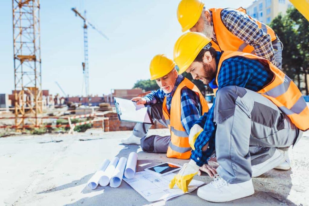 workers looking at some constructions plans and discussing about it