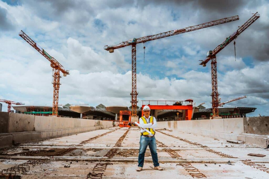 Construction Man standing in front of a construction in process