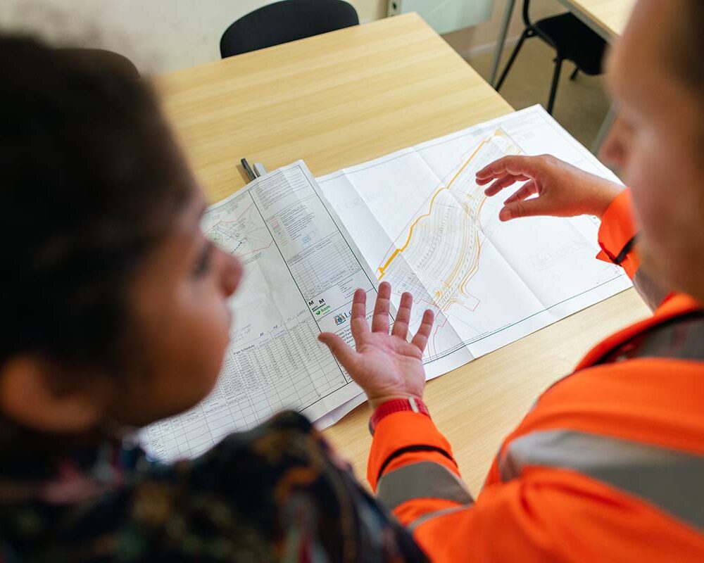 An engineer and project manager discuss a project involving commercial contracting in Austin, TX