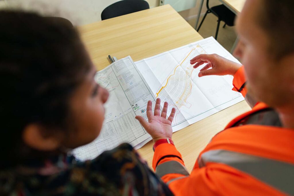 An engineer and project manager discuss a project involving commercial contracting in Austin, TX