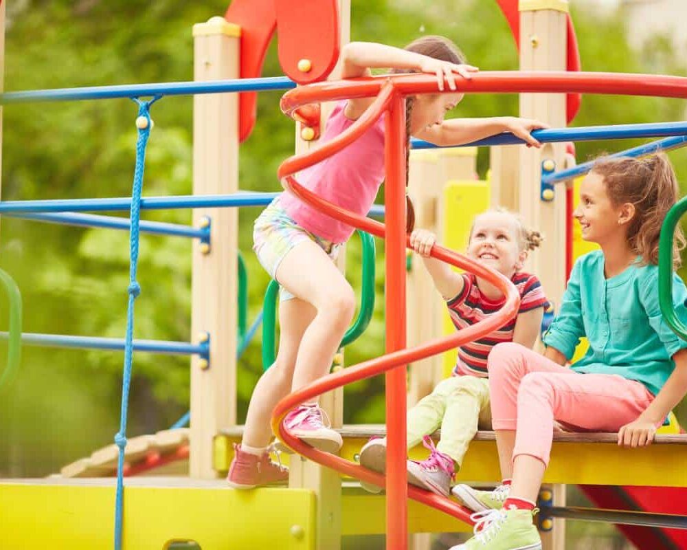 Colorful Austin playground equipment on a sunny day with a slide and climbing frames.