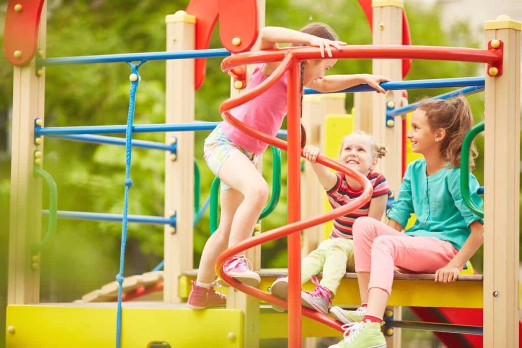 Colorful Austin playground equipment on a sunny day with a slide and climbing frames.