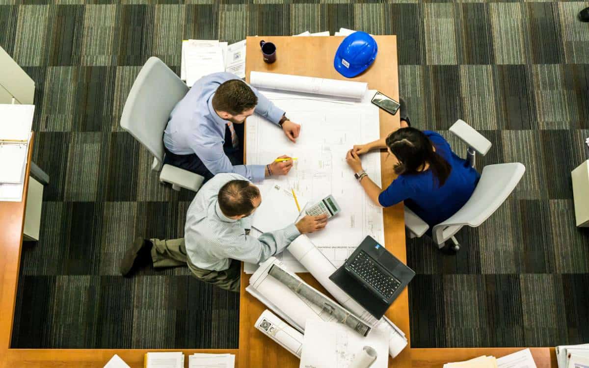 Commercial Construction Workers in a Meeting Room Discussing the Project