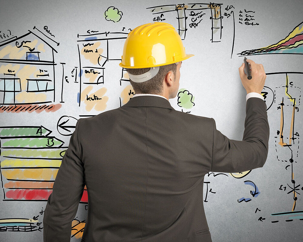 An engineer planning an Austin construction project on a whiteboard.