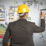 An engineer planning an Austin construction project on a whiteboard.