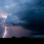 A fierce storm is pictured with lightning striking.