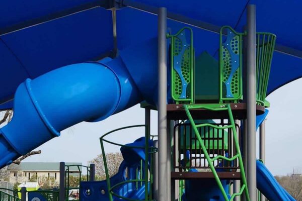 Blue playground slide at T.F. Harper & Associates LP featuring colorful climbing structures and safe recreational equipment.